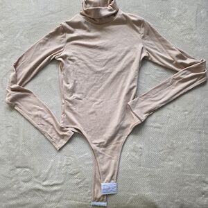 Shop Boyed Ribbed Turtleneck Bodysuit with Thumbholes - Oatmeal